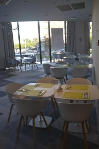 a group of tables and chairs in a room at Ibis Styles Wroclaw Centrum in Wrocław