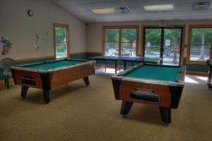 two pool tables in a room with windows at Foxhunt at Sapphire Valley in Sapphire