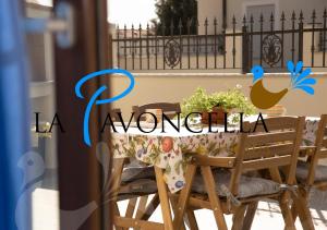 tavolo da pranzo con una tovaglia e una pianta di Case Vacanze La Pavoncella a Teulada