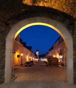 um arco sobre uma rua à noite com uma torre do relógio em Ferienwohnung Buschbeck em Marienberg
