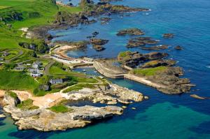 an aerial view of a rocky island in the ocean at Causeway Bay Guesthouse Portrush in Portrush