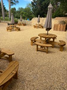 a group of picnic tables with umbrellas in a park at Horse & Hound Inn in Broadway