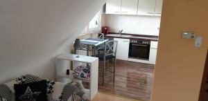 a small kitchen with a sink and a table in a room at Sebol in Immendingen