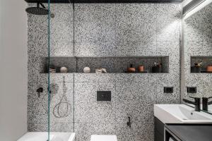 a bathroom with a shower and a sink at Mr. Montana - By TLV2GO in Tel Aviv