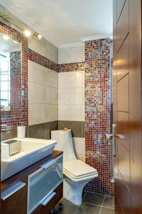 a bathroom with a toilet and a sink at Yoga Euphoria seaside apartment in Artemida