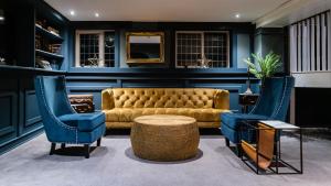 a living room with a couch and two chairs at The Bridge in Macclesfield