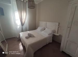Łóżko lub łóżka w pokoju w obiekcie Villa Blanco's