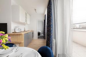 a kitchen with a table and chairs in a room at Short Stay Apartments in Gdańsk