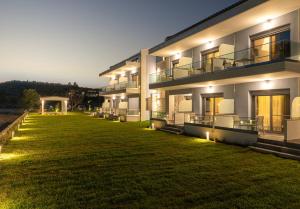 a building with a large lawn in front of it at Notia Luxury Living in Porto Koufo