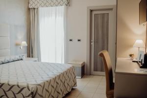 Postel nebo postele na pokoji v ubytování Hotel Niagara