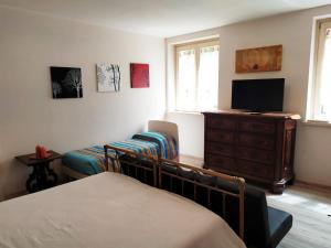 Appartamento Corte dei Landi في Cavriago: غرفة نوم بسرير وتلفزيون وخزانة