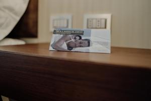 a magazine sitting on top of a wooden table at Hotel Niagara in Catanzaro Lido