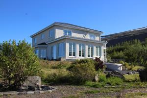 a large house on top of a hill at Villa Mafini in Akureyri