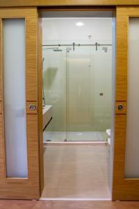 a glass shower door in a bathroom at Boutique Mouras in Mondim de Basto