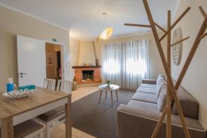 a living room with a couch and a table at Casa da Praia in Zambujeira do Mar