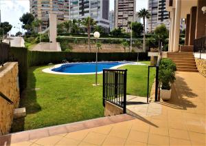 a yard with a swimming pool in a city at Pintor Rosales 3 dormitorios mirando al mar - Fincas Arena in Benidorm