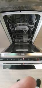 a dishwasher with the door open to show the inside at Gardenia Sea Side MARTINA 1 Dziwnów in Dziwnów +27 photos