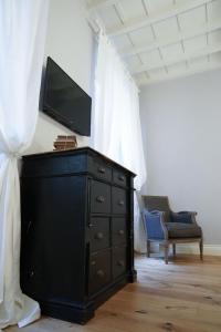 A television and/or entertainment centre at Art Apartment Black & White Suite