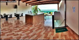 a lobby with a counter and chairs in a room at Pousada Boa Vista in Maragogi +71 photos