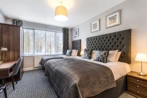Ένα ή περισσότερα κρεβάτια σε δωμάτιο στο Martel Guest House
