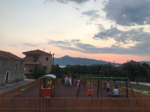 a group of people playing in a playground at BALATSOURAS APARTMENT in Paleros