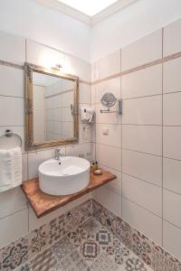 a bathroom with a sink and a mirror at Ameliko Zagori in Ano Pedina