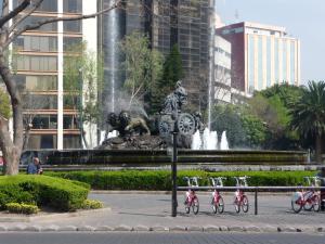 a group of girls on bikes in front of a fountain at Suites 259 Condesa in Mexico City