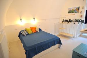 a bedroom with a bed with colorful pillows on it at da Nonna Lata in Martina Franca