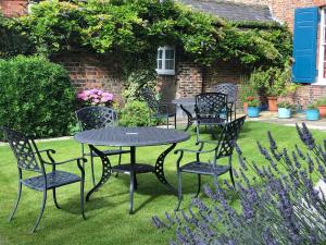a black table and chairs in a garden at The Bar Convent Guest House in York