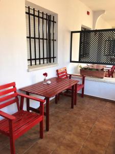 a wooden table and chairs in a room at Hostal Alhambra in Zahora