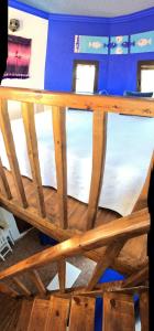 a wooden table with four windows in a room at Hostal Alhambra in Zahora