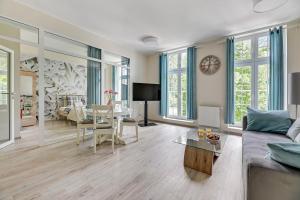 a living room with a couch and a table at Blue Mandarin Apartments II in Sopot