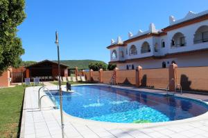 a large swimming pool in front of a building at Hostal Alhambra in Zahora