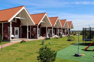 a group of houses with a playground at Baltic Dream Vasarnamiai in Šventoji
