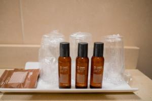 three bottles of hair products sitting on a tray at Compostela Suites in Madrid