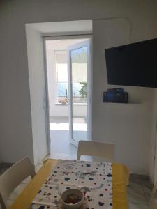 a dining room with a table and a view of the ocean at Palinuro Villa Bellavista in Palinuro