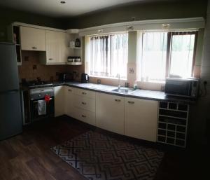 A kitchen or kitchenette at Dale Holiday Lets