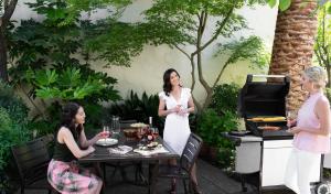 a group of women standing around a table with a grill at Roman Spa Resort in Calistoga