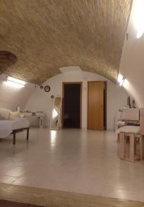 a large living room with a couch and a table at Residenza l'Orologio in Bernalda