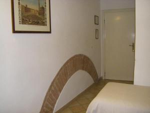 Postel nebo postele na pokoji v ubytování Albergo Cannon d'Oro