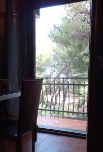 a door to a balcony with a view of a tree at Villa Morgante B&B in Pedara