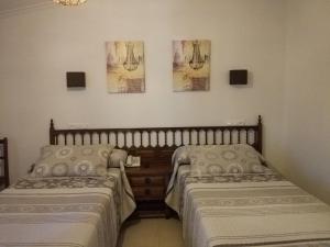 two beds sitting next to each other in a room at Hotel Estrella del Mar in A Lanzada