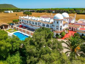 an aerial view of a large white house with a pool at Hostal Alhambra in Zahora