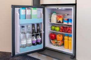an open refrigerator filled with lots of food and drinks at The Resident Soho in London