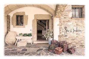 a bunch of luggage sitting outside of a building at Hotel Rec de Palau in Cadaqués