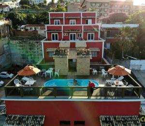 Bella Natal Praia Hotel في ناتال: اطلالة على مبنى مع مسبح على شرفة