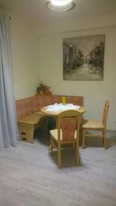 a living room with a couch and a table and chairs at ApartmentHotel Vollumen in Redwitz an der Rodach