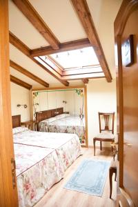 a bedroom with a bed and a chair and a mirror at Jausoro in Aretxabaleta