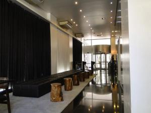 a lobby with a row of gold vases on a counter at 155 Hotel in Sao Paulo