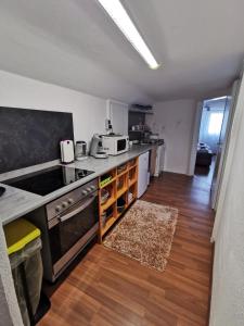 a kitchen with a stove and a counter top at M&M Apartments in Augustdorf